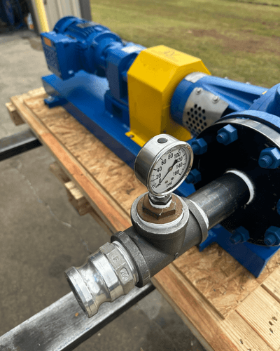 Desmi/Rotan gear pump and electric motor mounted on a blue painted baseplate, built by EV Pump & Equipment to suction-lift drilling mud for Aerion's ARM real-time monitoring system on active drilling rigs.