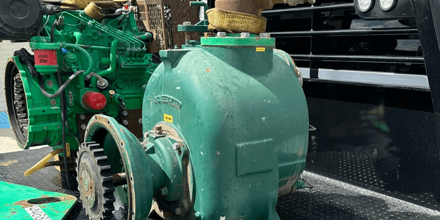 Large green centrifugal pump and diesel engine loaded on a service truck bed — EV Pump & Equipment field service and outsourced pump work, Lafayette, LA