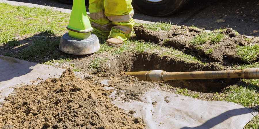 horizontal directional drilling in grass near a sidewalk