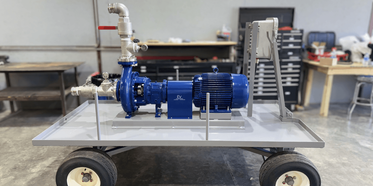 Blue ANSI centrifugal pump and electric motor mounted on a four-wheel mobile cart with stainless steel piping, ball valve, and camlock fittings, built by EV Pump & Equipment for rail car transloading operations at Cicada Logistics.