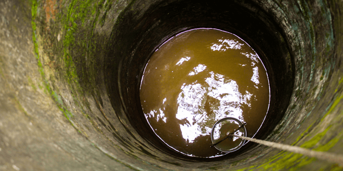 old water well with brown water inside requiring pump servicing