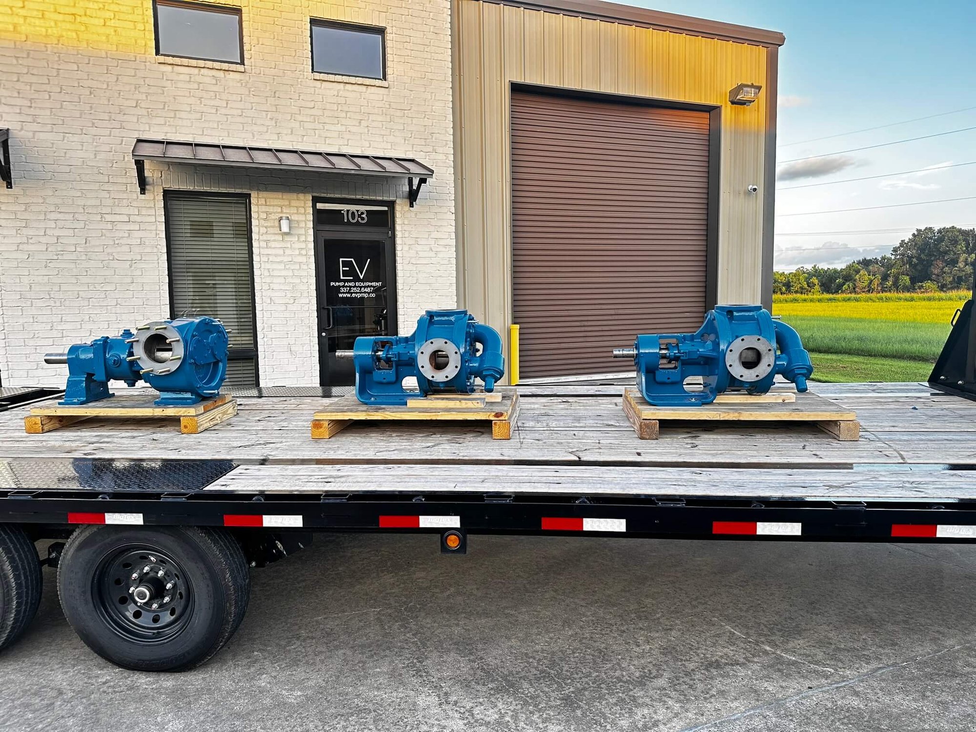 3 Viking Gear Pumps loaded on a flatbed trailer in front of EV Pump & Equipment in Scott, La